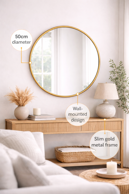Round mirror with gold frame in a living room setting