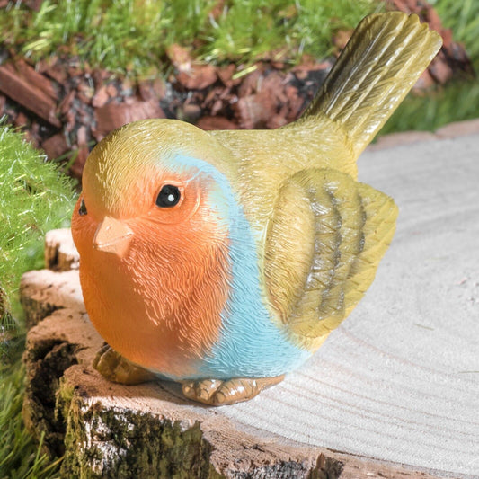 Colorful resin bird garden ornament perched on wood, perfect for outdoor decor and patio styling