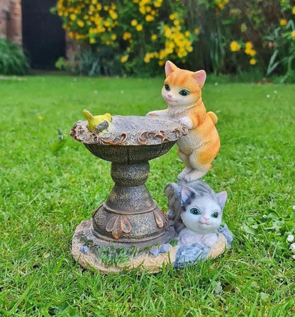 Solar cat bird bath ornament standing on a lawn