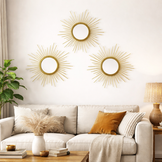 Living room with gold sunburst mirrors on the wall, a white sofa, and decorative items.