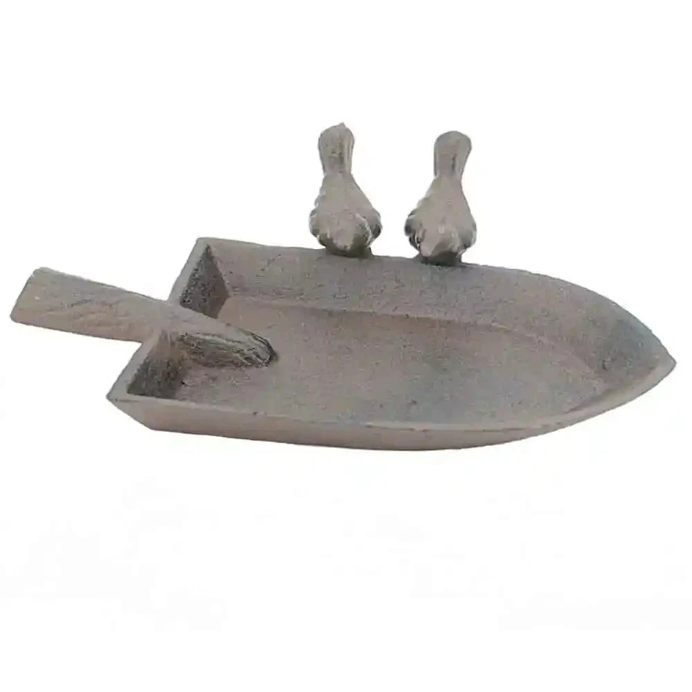 Decorative metal sculpture of a boat with two birds on a white background