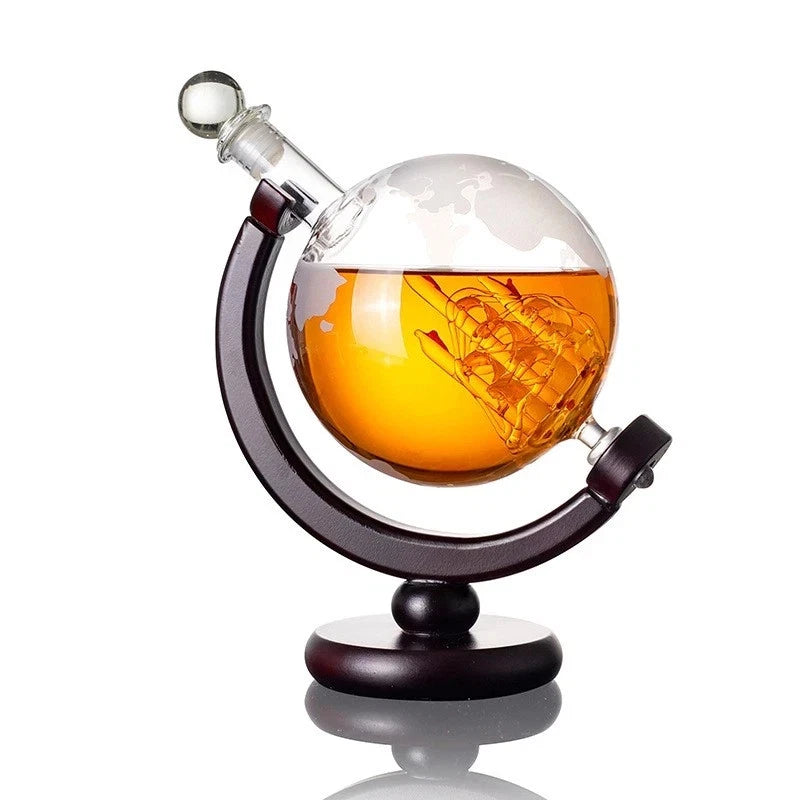 Globe-shaped decanter with amber liquid on a white background
