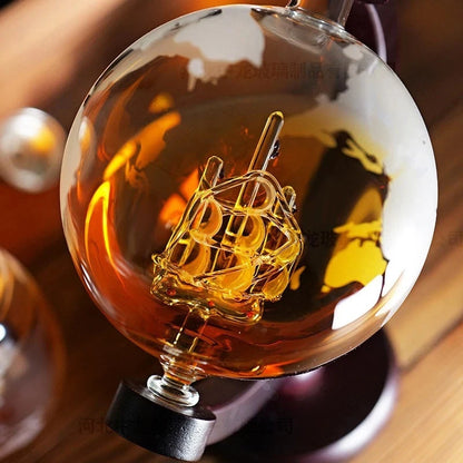 Decorative light bulb with ship design inside, on a wooden surface.