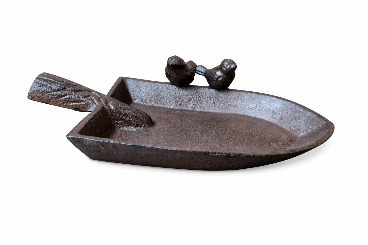 Cast iron dish shaped like a boat with two small figures on a white background