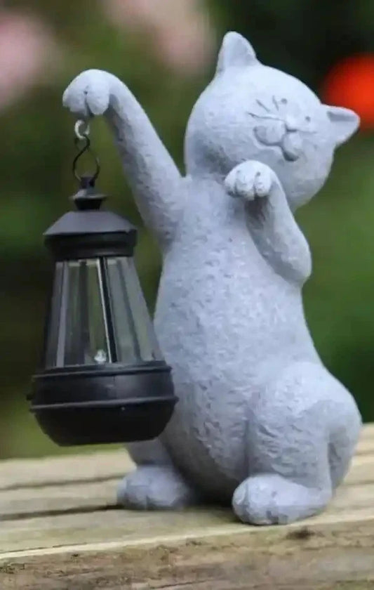 Cat-shaped solar lantern on a wooden surface with a blurred background