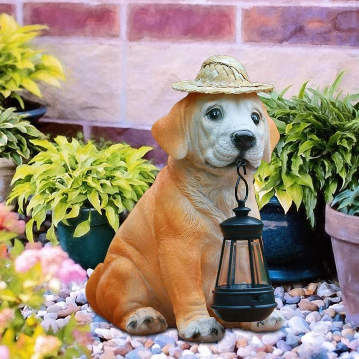 Dog statue with a hat and lantern in a garden setting