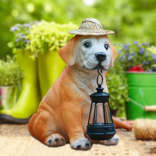 Dog-shaped garden statue with a hat and lantern in a garden setting