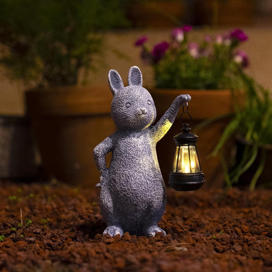 Solar rabbit ornament glowing at night in garden